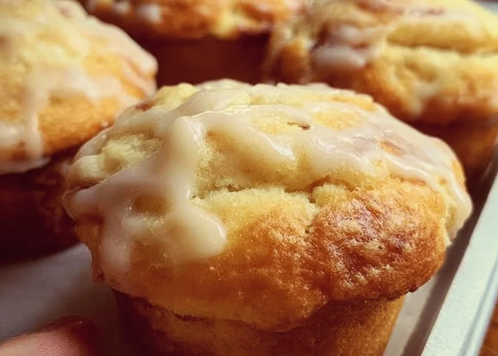 Gluten-free cream cheese frosted muffins on a plate